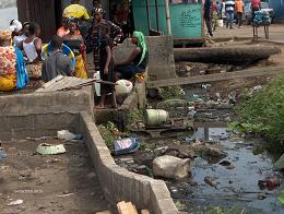 Monrovia's Slum:Clara Town Residents Fetch Water Next to a Nasty Drainage